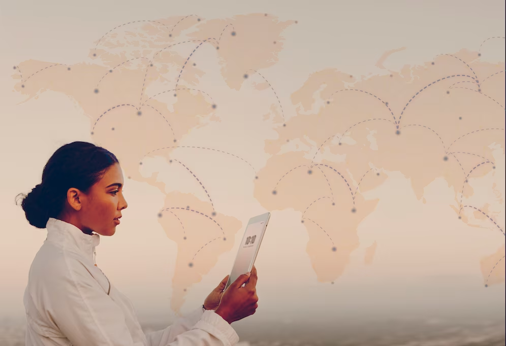 Side view of a woman holding a tablet with a map in the background