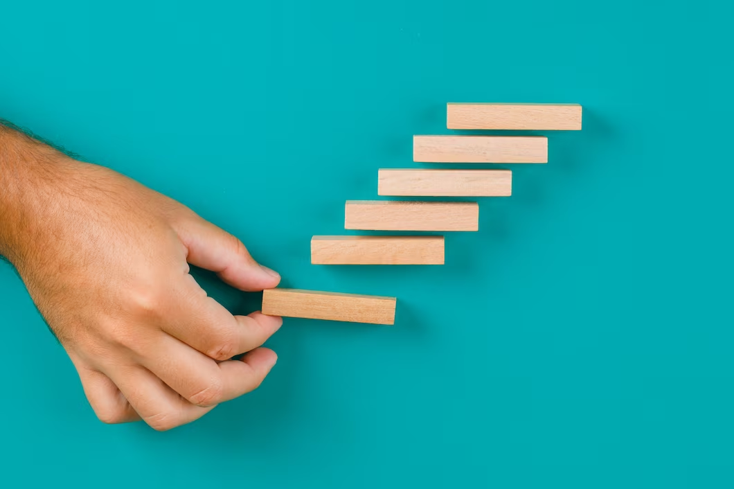 Hand stacking wooden pieces in an elevating formation